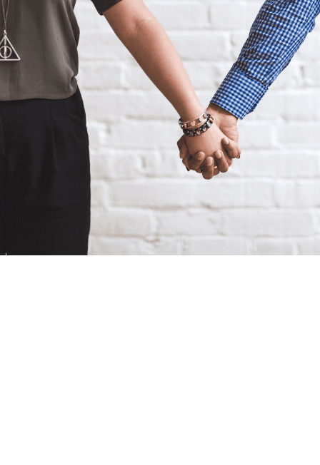 Two people holding hands symbolizing support and unity